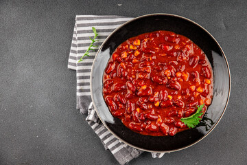 Chile con carne dish plate bean, tomato, corn, meat fresh gourmet food background on the table rustic food top view copy space