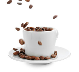 Roasted coffee beans falling into cup isolated on white