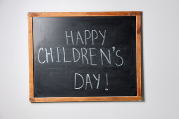 Phrase Happy Children’s Day with exclamation mark on blackboard