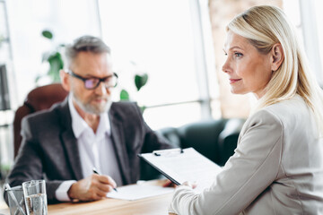 Obraz premium Professional business meeting with senior executive colleagues discussing work collaboration in a corporate office environment