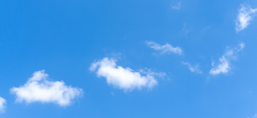 Low angle view and full frame of beautiful blue sky with strange shape of white fluffy clouds in the morning or afternoon  on sunny day used as natural background texture in decorative art work