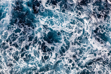 Ocean water surface background. Aerial view of picturesque foamy water. Can be used in covers, packaging, posters, textures, cards, art and design projects. Breathtaking nature background image.