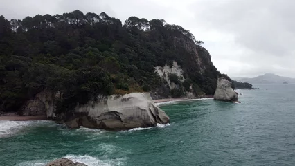Gordijnen Cathedral Cove Beach, New Zealand – Aerial Drone Footage of Iconic Coastal Rock Arch and Turquoise Waters © Aelis Vision