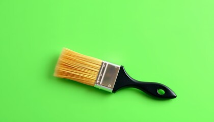 Paintbrush with Yellow Bristles and Black Handle Isolated on Green Screen Background
