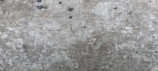 Grungy Weathered Concrete Surface Texture. Close-up of an old, weathered concrete wall texture with cracks and dark spots. Ideal for backgrounds, design overlays, or industrial themes