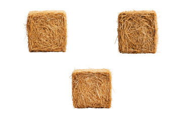 Dry straw hay bales stacked in rural farm field