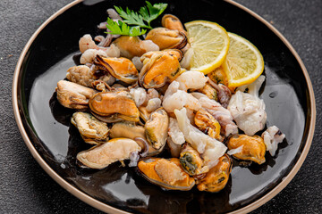Seafood bowl shrimp, prawn, rapan, squid dish fresh gourmet food background on the table rustic food top view copy space keto  paleo diet vegetarian pescetarian diet