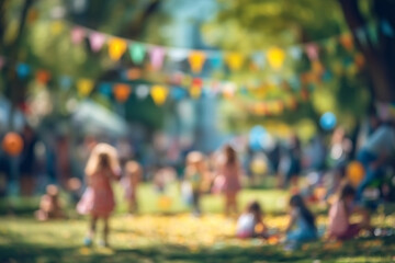 Obraz premium Blurred summer outdoor event with children playing and colorful flags, family festival on a sunny day in green park