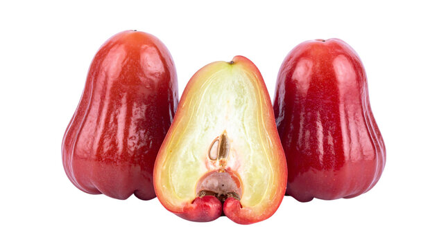 Three wax apples close-up, halved (white-yellow flesh/seeds), two whole (bright red/glossy), white background or png.