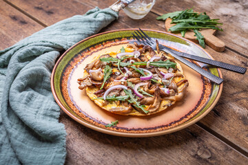 Vegetarian fritatta with mushrooms, onions and  arugula