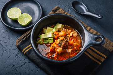 Spicy red curry soup with chicken, shrimps and avocado