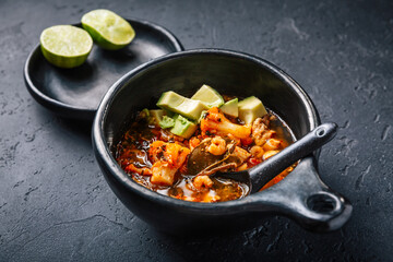 Spicy red curry soup with chicken, shrimps and avocado