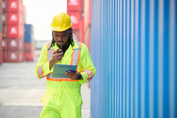 Worker or engineer using walkie talkie and talking about work in containers warehouse storage
