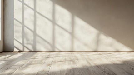 Empty room with a wooden floor and a large window on the left side. the walls are painted in a light beige color and the floor is made of light-colored wood planks.