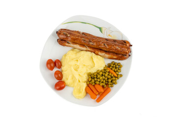 A plate with bratwurst, mashed potatoes, peas, carrots, and tomatoes. The ingredients are clearly arranged and color-contrasting.