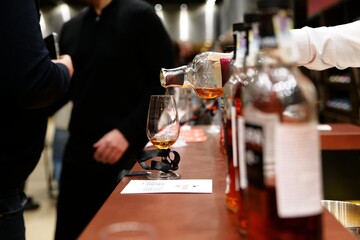 Enjoying fine spirits at a whiskey tasting event in a modern bar setting
