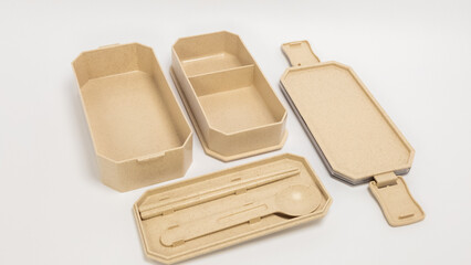 Beige Bento Box Set with Chopsticks and Spoon on White Background