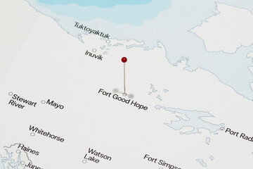 macro photo of a red pin needle into fort good hope city of Canada political map