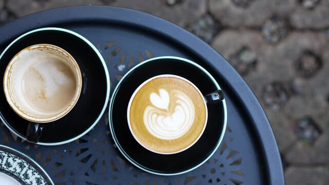 flat lay footage of fresh and drinked cappuccino coffee new and old concept slow motion latte art espresso