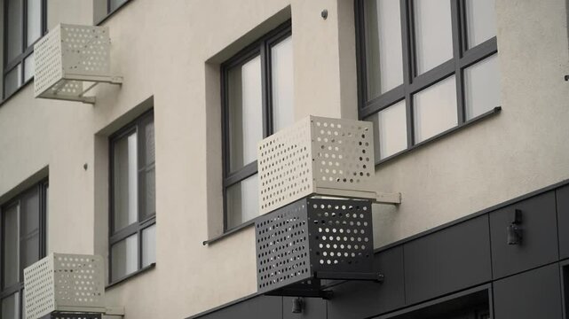 Air conditioning baskets on the white and black fasade of a residential building
