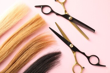 Hair strands and hairdresser's tools on light pink background, flat lay