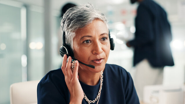 Mature woman, consultant and talking with headset at call center for online communication. Female person, agent or employee speaking with mic or technology for virtual assistance or help at office - Powered by Adobe
