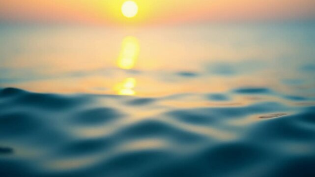 Abstract calm sea summer ocean sunset nature background. Small waves on water surface in motion blur with golden bokeh lights from sun. Holiday, vacation and recreational concept. Slow motion