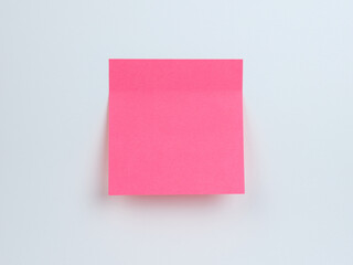Bright pink sticky note on a plain background