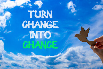 Turn change into chance symbol. Concept words phrase Turn change into chance on beautiful sky....