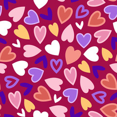 Modern multicolored hearts in seamless pattern on red background