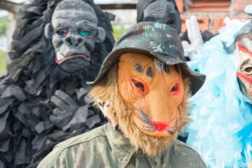 Unidentified people dressed in terrifying costumes in a rural area.