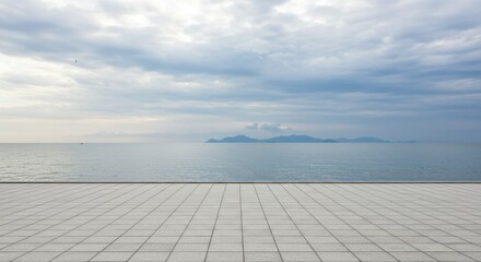 Seascape view reflecting tranquility and serenity, with cloudy sky and tiled floor