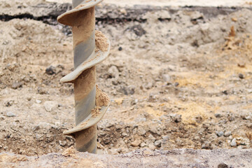 Soil auger, close-up. Construction special equipment. Repair work. Construction activity at a construction site. Close-up of drilling equipment. Geotechnical drilling