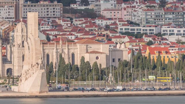 Aerial timelapse of Mosteiro dos Jeronimos and Monument to the Discoveries in the Belem district of Lisbon, Portugal. Manueline architecture with marina boats on Tejo River and people on a waterfront