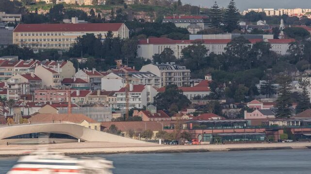 Aerial timelapse of MAAT (Museum of Art, Architecture, and Technology) on the Tagus River waterfront in Lisbon's Belem district. Scenic views include historical houses and construction site cranes