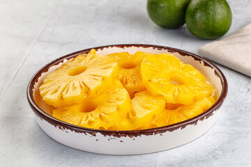 Sweet canned pineapple slices in syrope