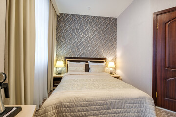 Interior of modern luxure bedroom in studio apartments or hotel with double master bed