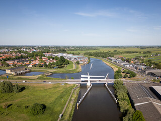 Netherlands civil engineering bridge structure between Dutch city Gouda and Gouderak, Gouderakse brug over Hollandse Ijsel transportation infrastructure connection on sunny day with cars 