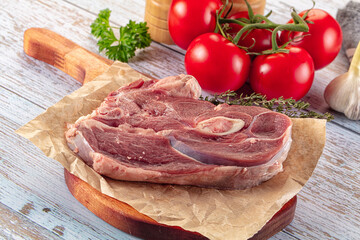 Raw lamb steak with bone