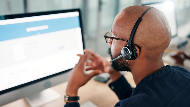 Computer screen, man and back of call center consultant in office for online consultation with crm. Contact us, help and African male tech support agent with service for troubleshooting problem.