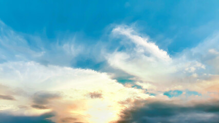 Blue sky and soft clouds background at sunset or sunrise. Natural light or gradient sunlight concept in summer.
