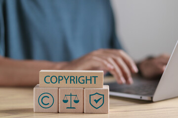 Copyright or patent concept. Author rights and patent intellectual property. Wooden blocks with...