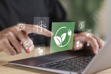 Renewable energy sources and alternative energy sources concept. Person using laptop with renewable...