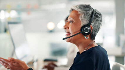 Fototapeta na wymiar Mature woman, agent and talking with headset on computer for online advice or customer service. Female person, consultant or employee with mic or technology for virtual assistance at call center