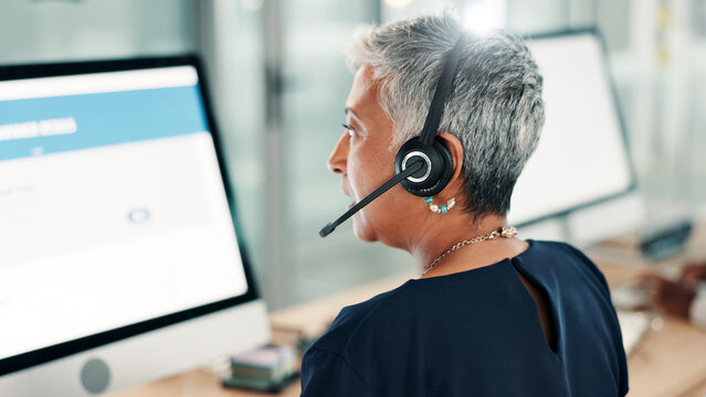Computer screen, woman and back of call center consultant in office for online consultation with crm. Contact us, help and mature female tech support agent with service for troubleshooting problem.