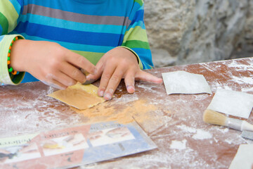 Set for children's creativity. Boy's hands grinding a stone.
