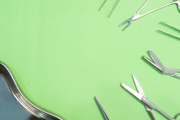 Set of Surgery Instrument over Green background. Include Scissors and forceps. Medical equipment kit