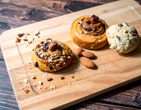 Variety of baked pastries with nuts on wooden board