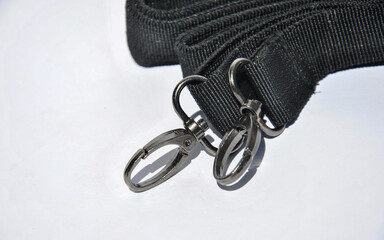 bag strap with carabiners on a light background