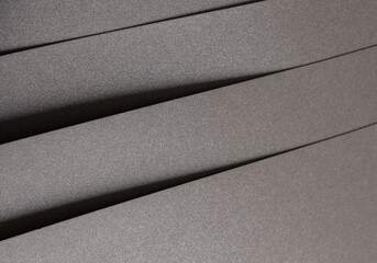 Gray paper texture with a shimmering, glistening finish, featuring a modern, abstract design.